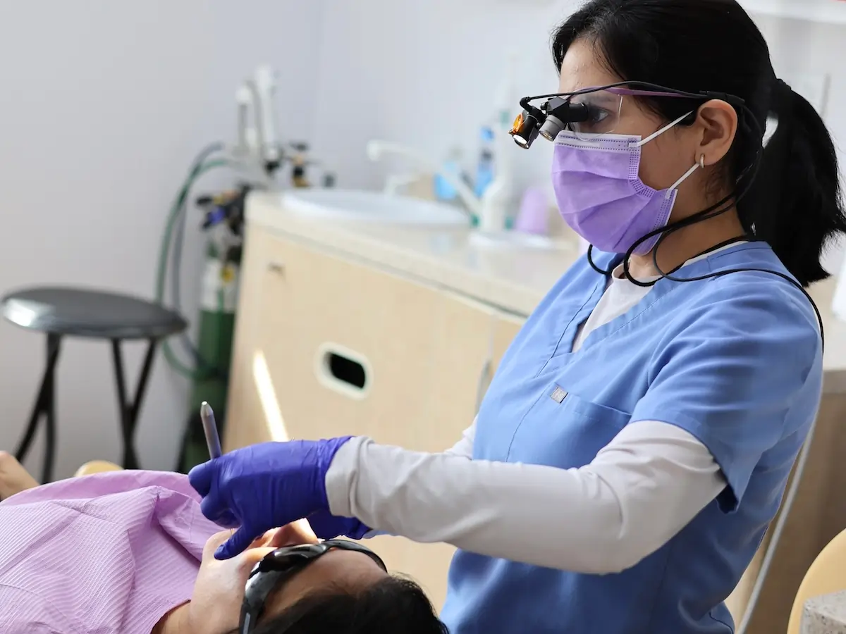 Dr. Edda Sidorova performing dental treatment on a patient at Bridgepointe Dental Studio in Metuchen, NJ